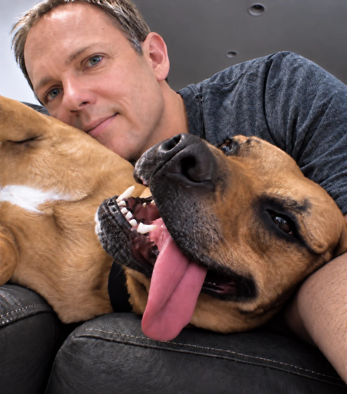 Christopher and Waffles relaxing together on a couch.